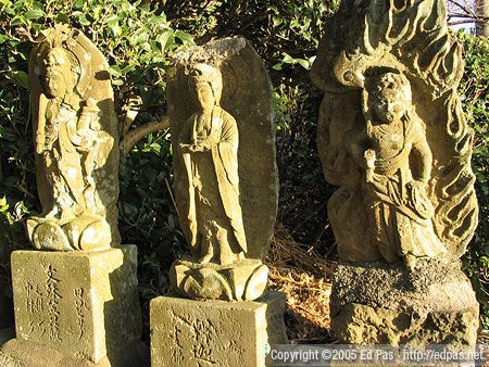 three statues in late-afternoon sunlight, along the road to Amida-in