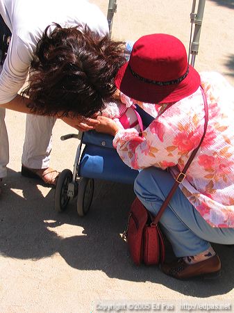 photo of two women fussing over an infant in a stroller