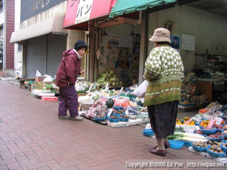 ladies in front of vegetable shops in Tobata Tenjin