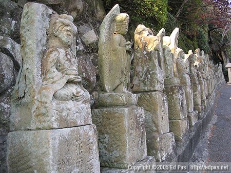 a long row of statues along the driveway up to Amida-in