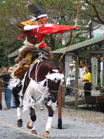 a horse-mounted archer aims at a target (closeup)