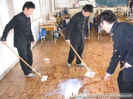 photo of boys attempting to wax their classroom floor