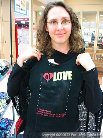 Lia holding a poetic tank top at Tobata SATY department store