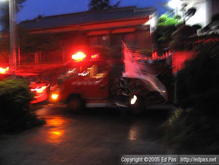 just-arrived fire truck, with fireman directing traffic with a big flag