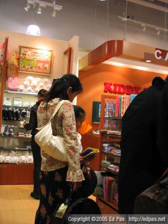 a mother browsing the shelves of Kiddyland in Riverwalk