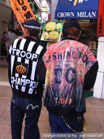 two young men in colourful sportwear strutting their stuff in front of Crown Milan bakery in the Kokura arcades