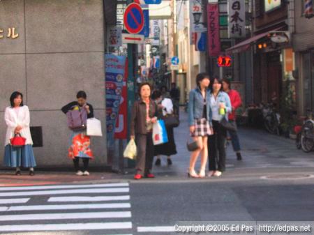 people waiting to cross a street in Kokura