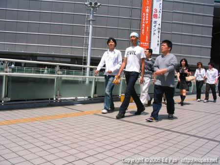 group of men, one with a shirt that says 'evil'