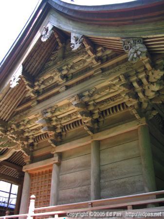view of the elaborate woodwork under the eaves of the third shrine building