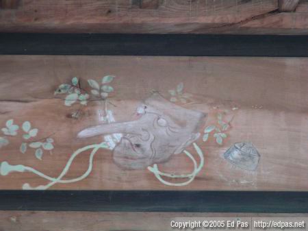 faded painting above the rear beam, inside the front building of Nishi Ono Hachimangu, of a long-nosed mask
