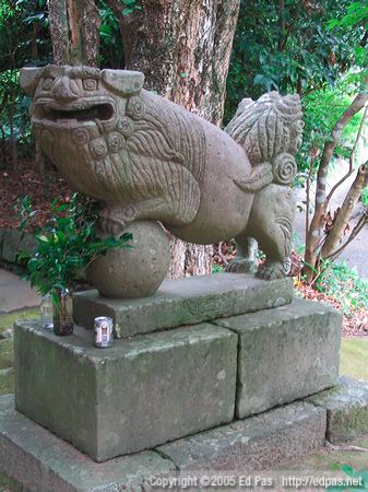 Sumerian-looking lion dog, with beer, at a shrine in Miyazaki City