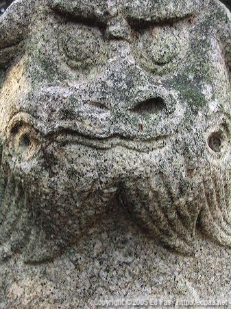 detail of closed-mouthed shishi at abandoned shrine near the coast along Wakamatsu north shore, Kitakyushu