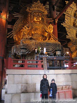 Lia and Jarrod standing in front of one of the Buddhas inside Todaiji Temple, Nara